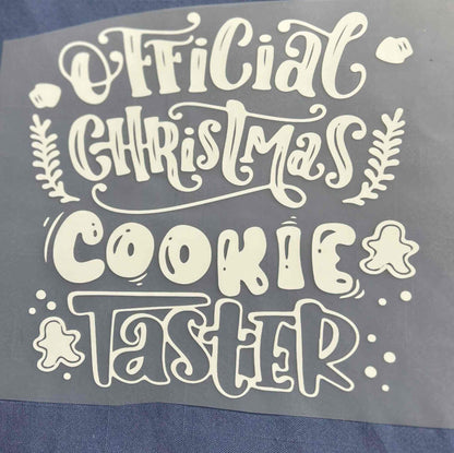 Holiday and season design with &quot;Official Christmas Cookie Taster&quot; text in festive style.