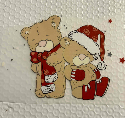 Festive teddy bear design with holiday accessories.