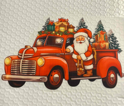 Santa Claus driving a festive red truck loaded with Christmas gifts and trees, showcasing holiday design.