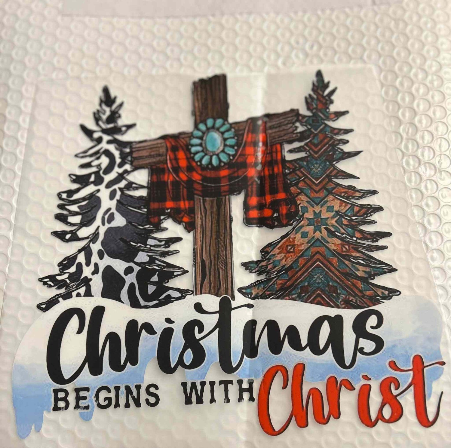 Holiday and season design featuring Christmas theme with trees, cross, and message &quot;Christmas Begins with Christ.&quot;