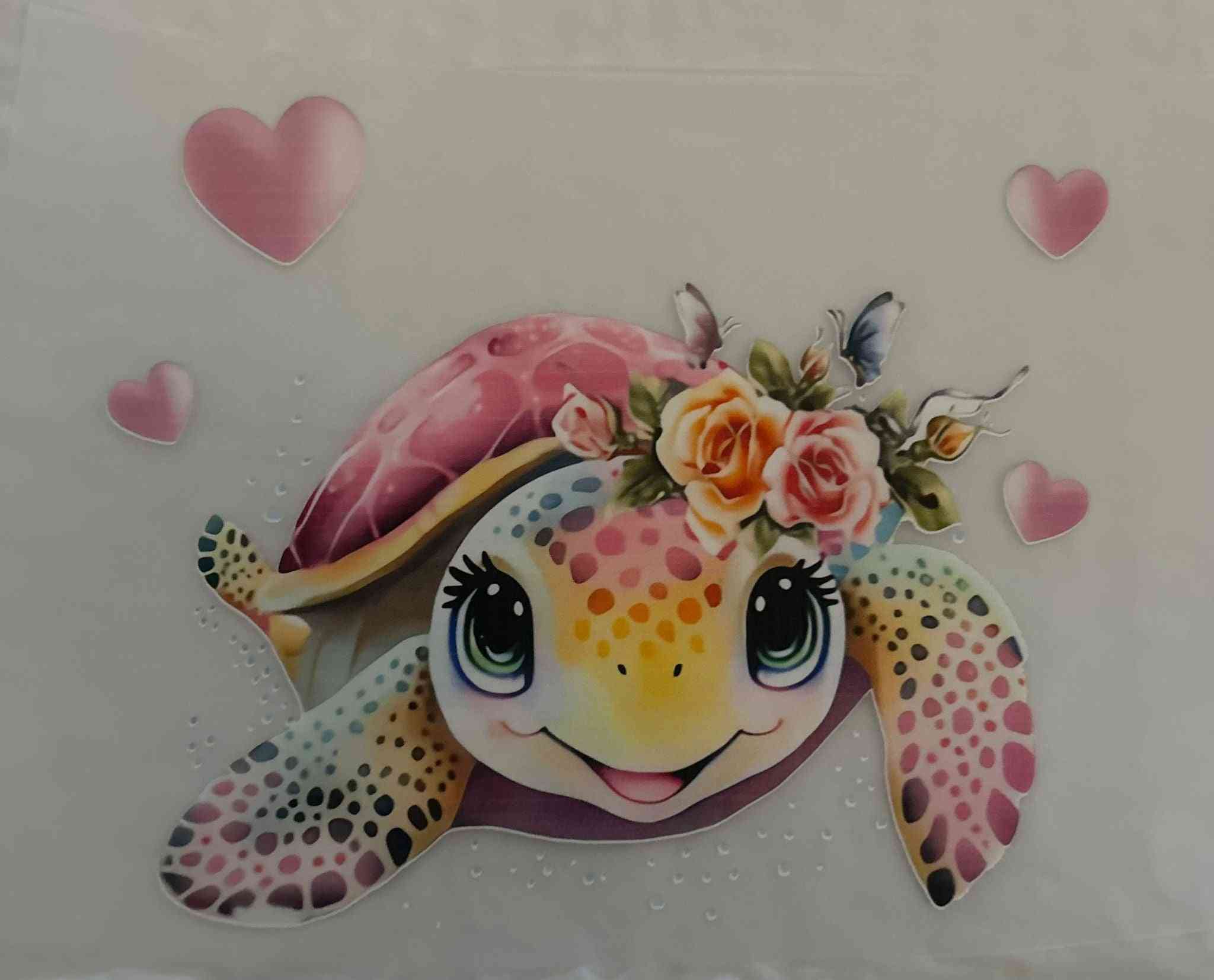 Colorful animal design featuring a turtle with floral accents and heart motifs.