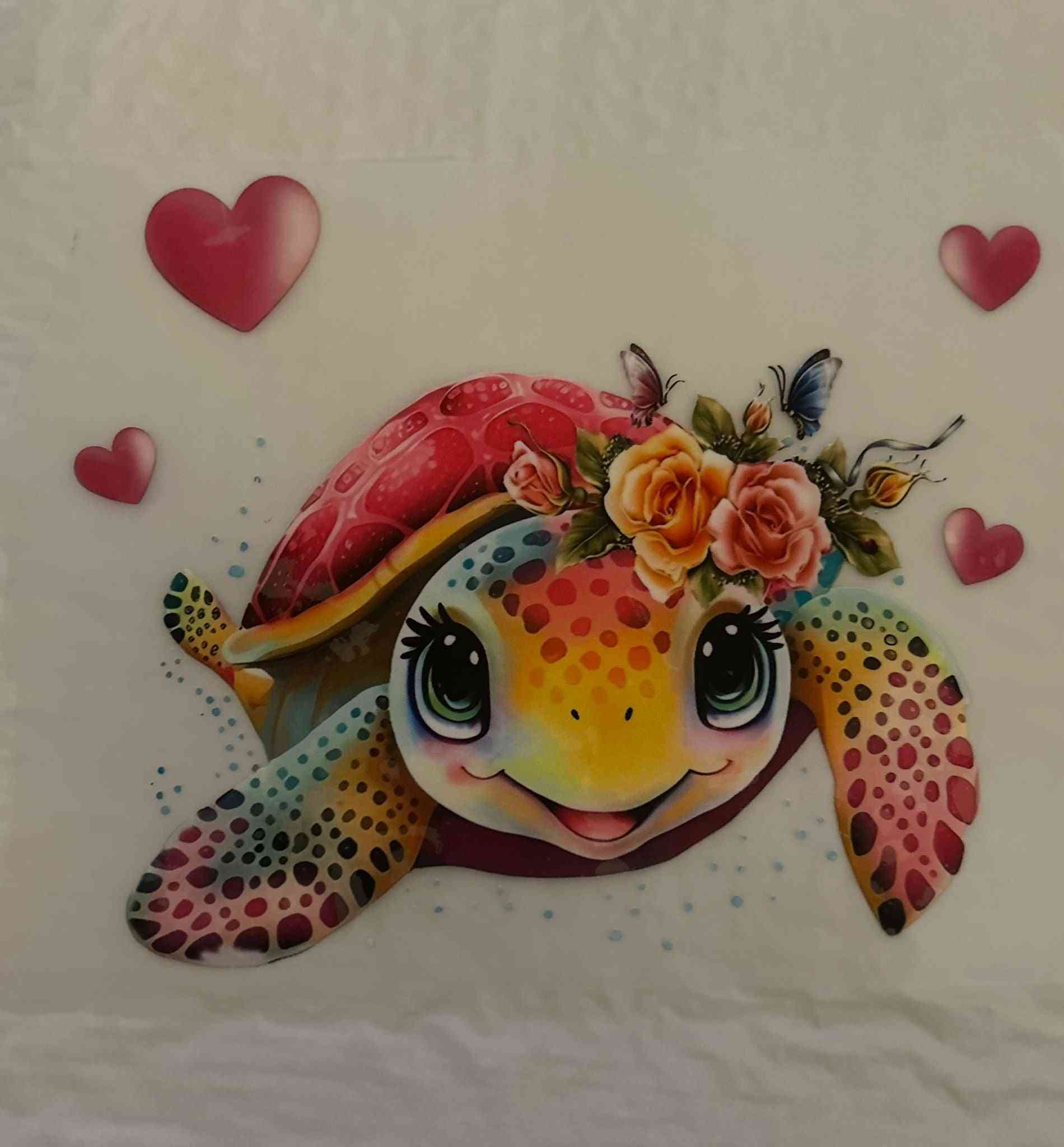 Colorful animal design featuring a turtle with floral accents and hearts.