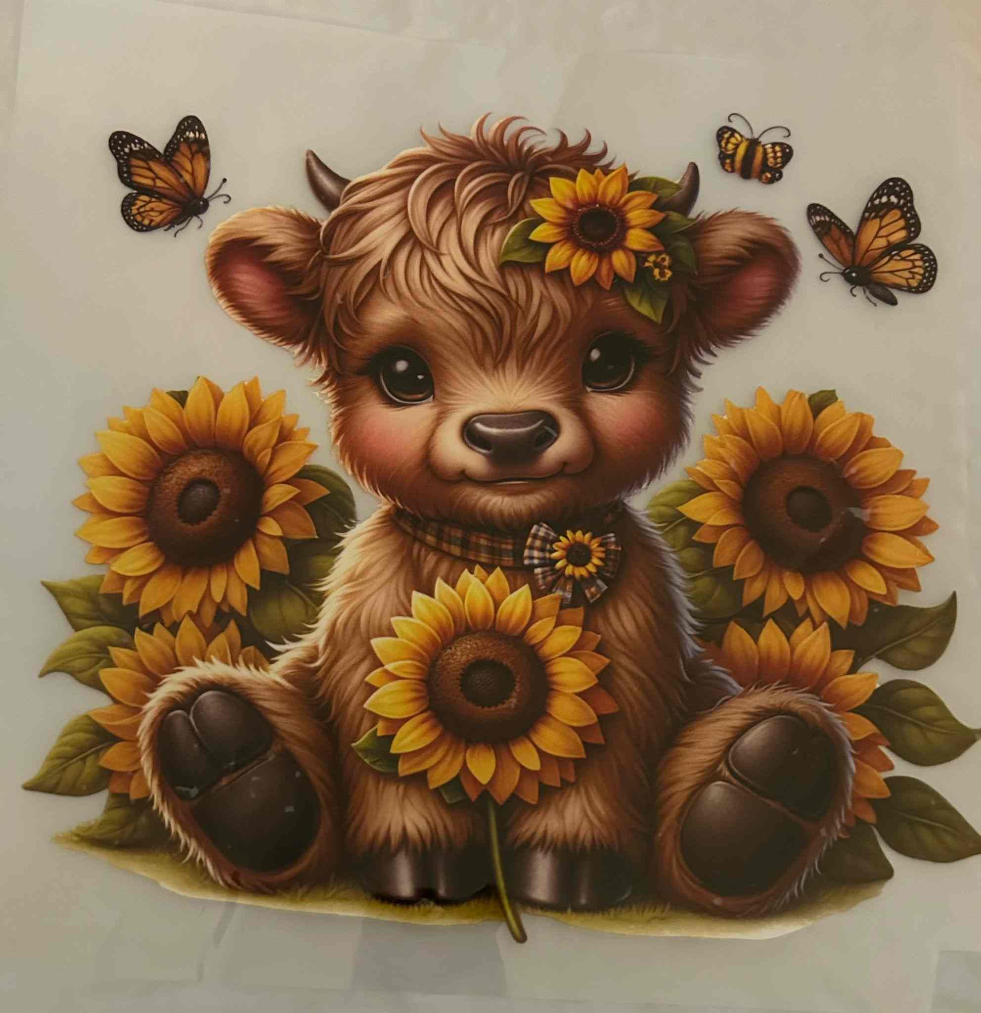 Cute animal design featuring a fluffy creature with sunflowers and butterflies.