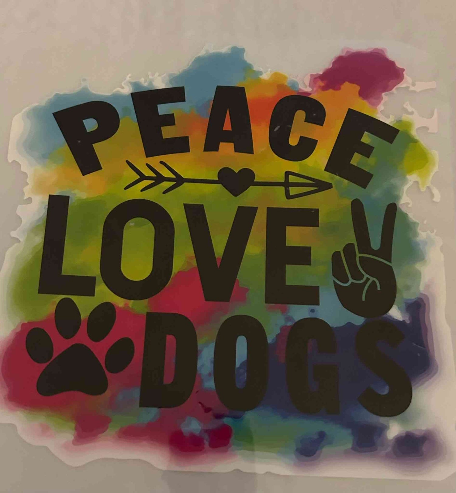 Peace Love Dogs animal design sticker with vibrant rainbow background.