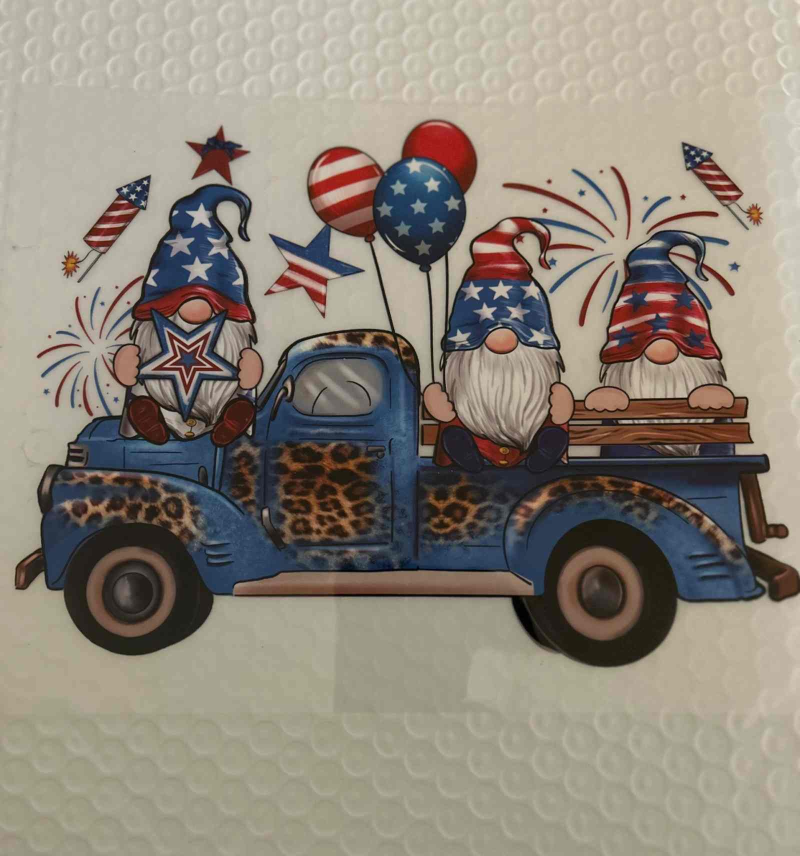 Vintage truck with patriotic gnomes and balloons.