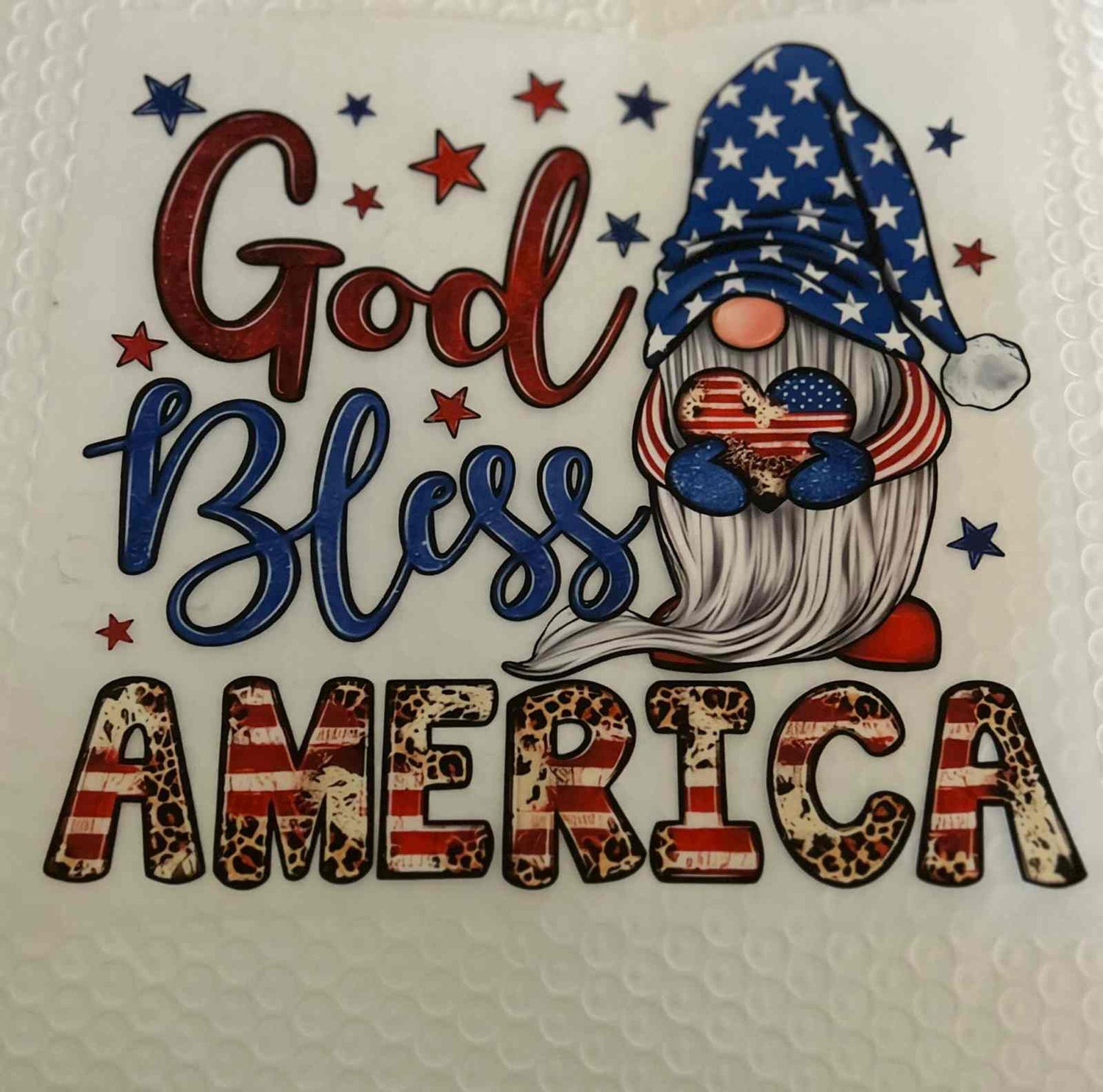 Patriotic design featuring &quot;God Bless America&quot; with gnome in American flag colors.