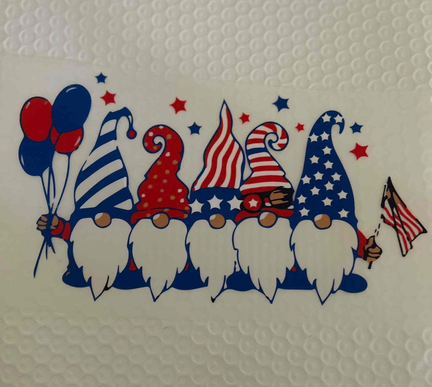 Patriotic gnomes with American flag designs, balloons, and stars.