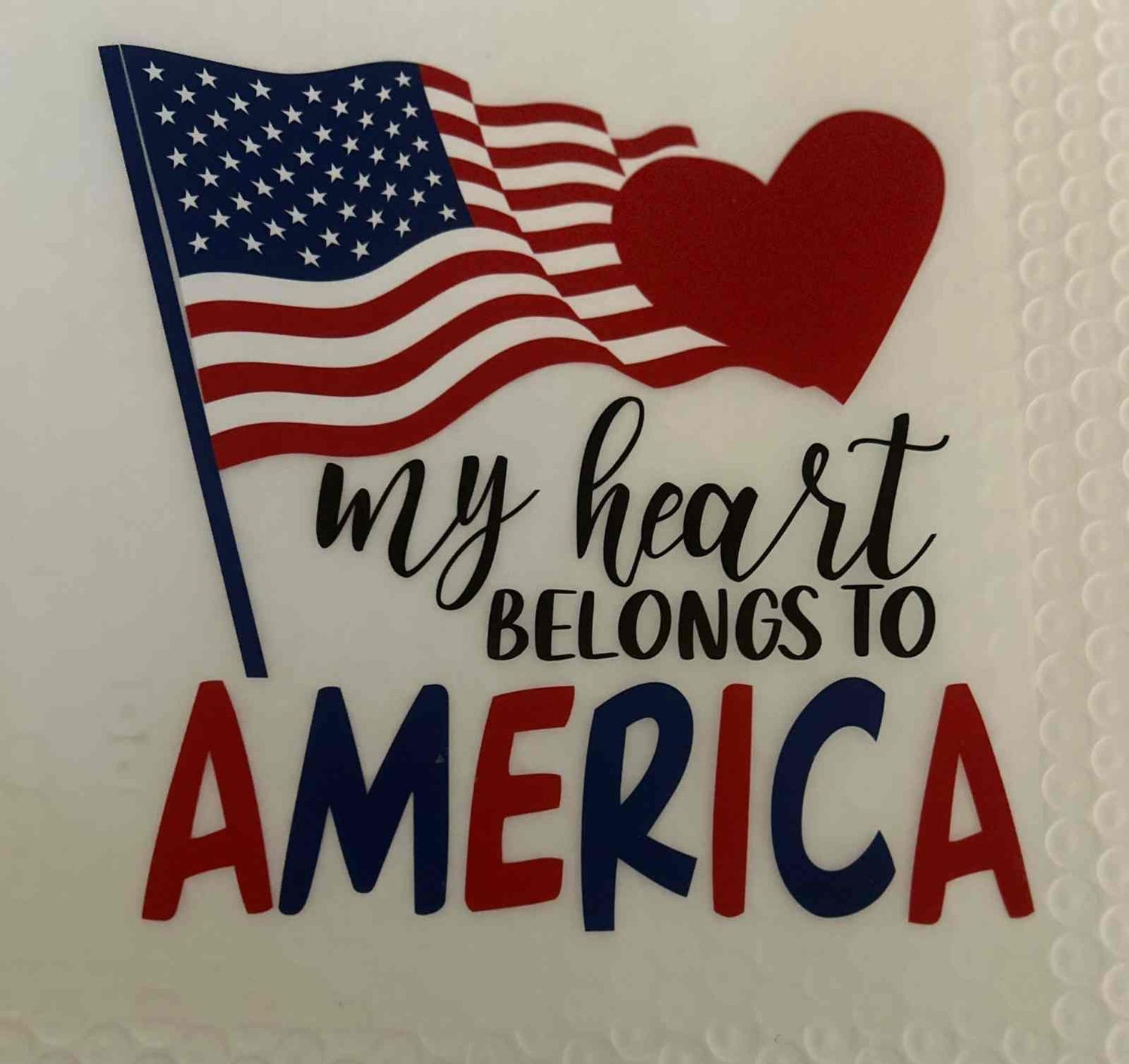 Patriotic design with American flag and &quot;My Heart Belongs to America&quot; message.