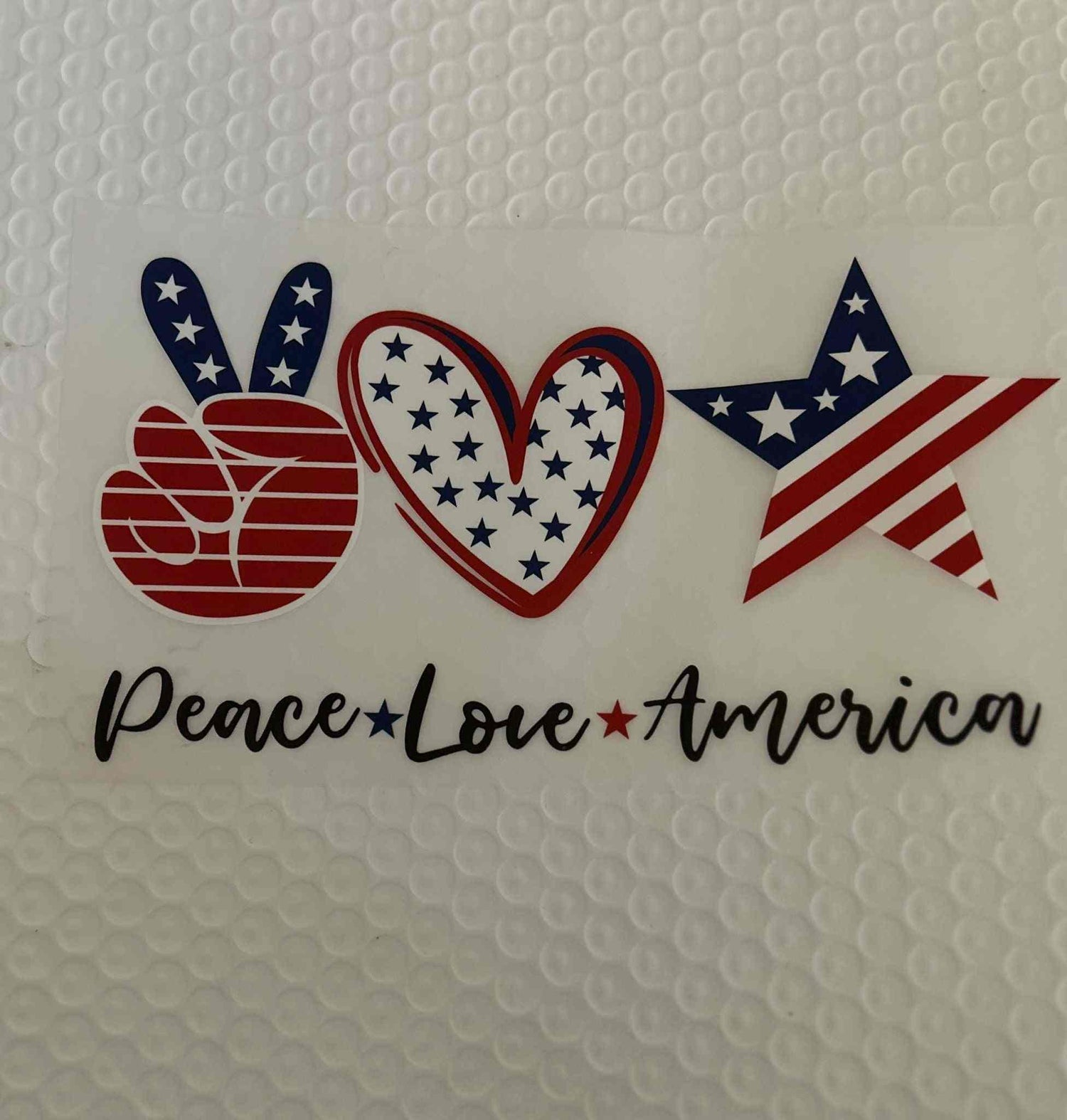 Patriotic Design with peace, love, and America symbols in red, white, and blue.