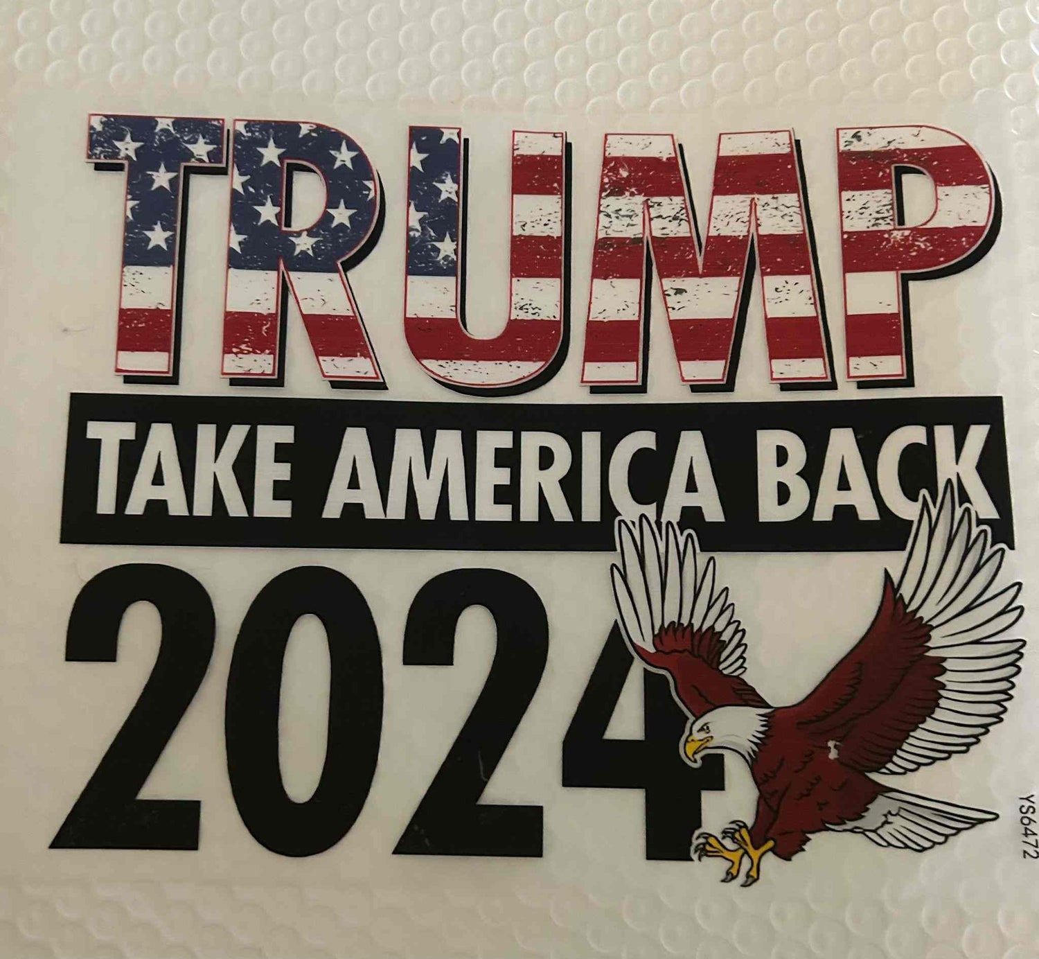 Patriotic design sticker with &quot;Trump Take America Back 2024&quot; and American flag theme.