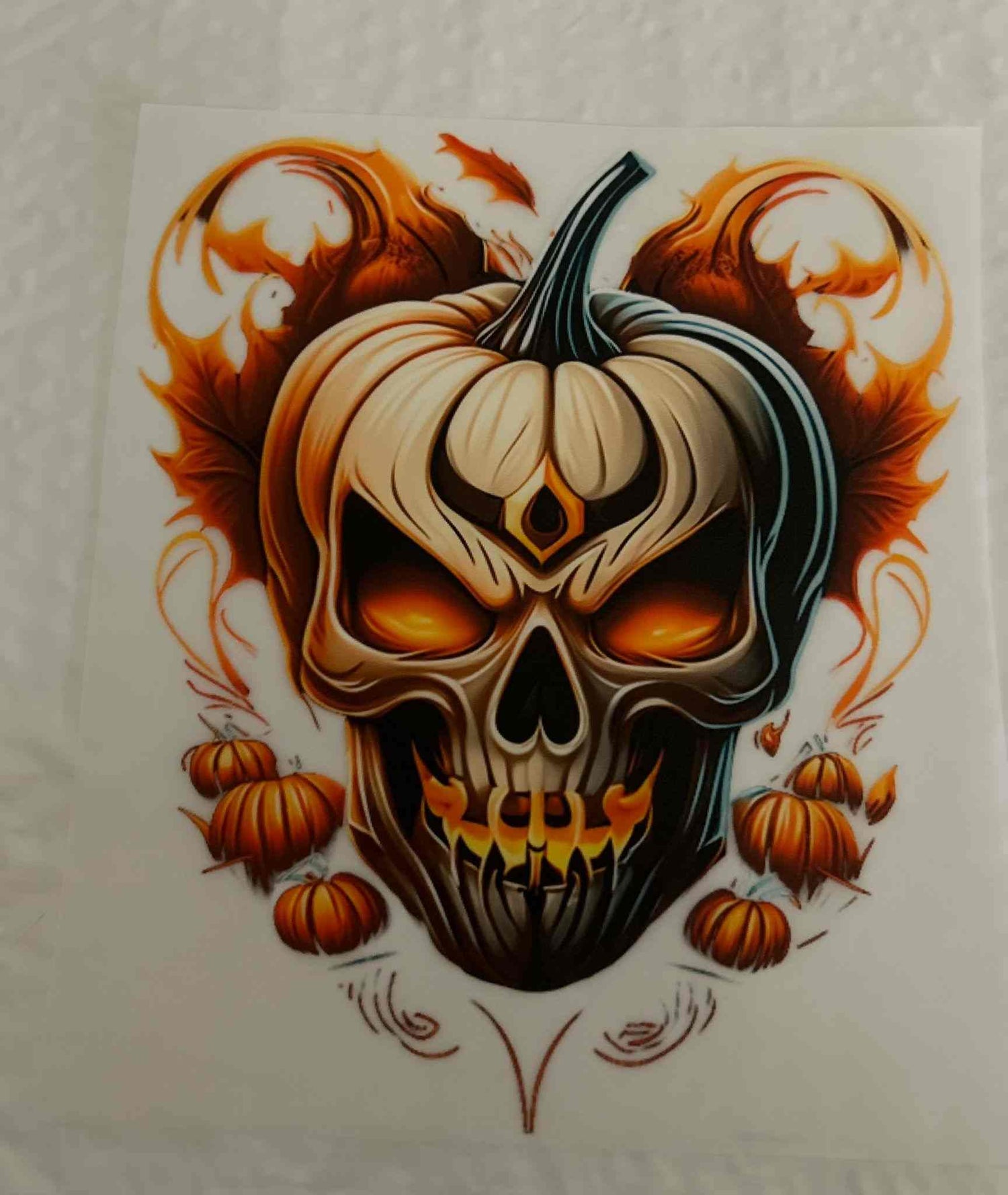 Holiday and season design featuring a detailed pumpkin skull with fiery accents.