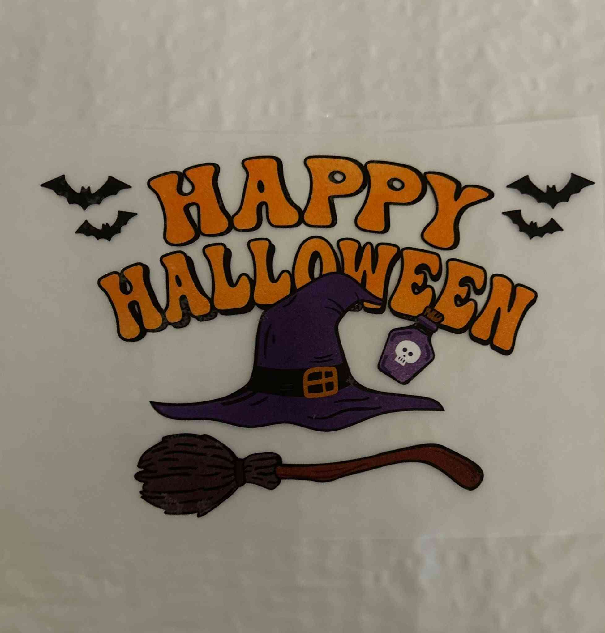 Happy Halloween design with witch hat, broom, and bats.