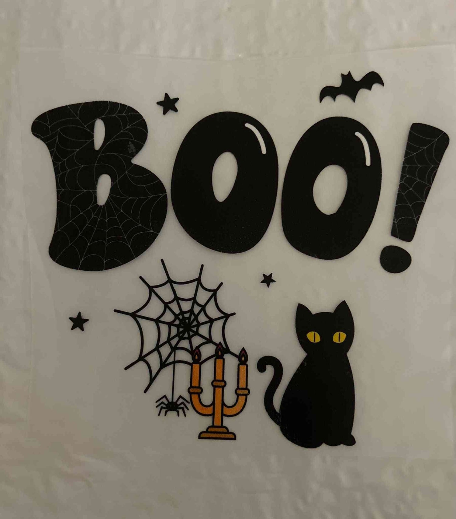 Halloween design featuring &quot;Boo!&quot; text with spiders, spiderweb, bat, black cat, and candle holder.