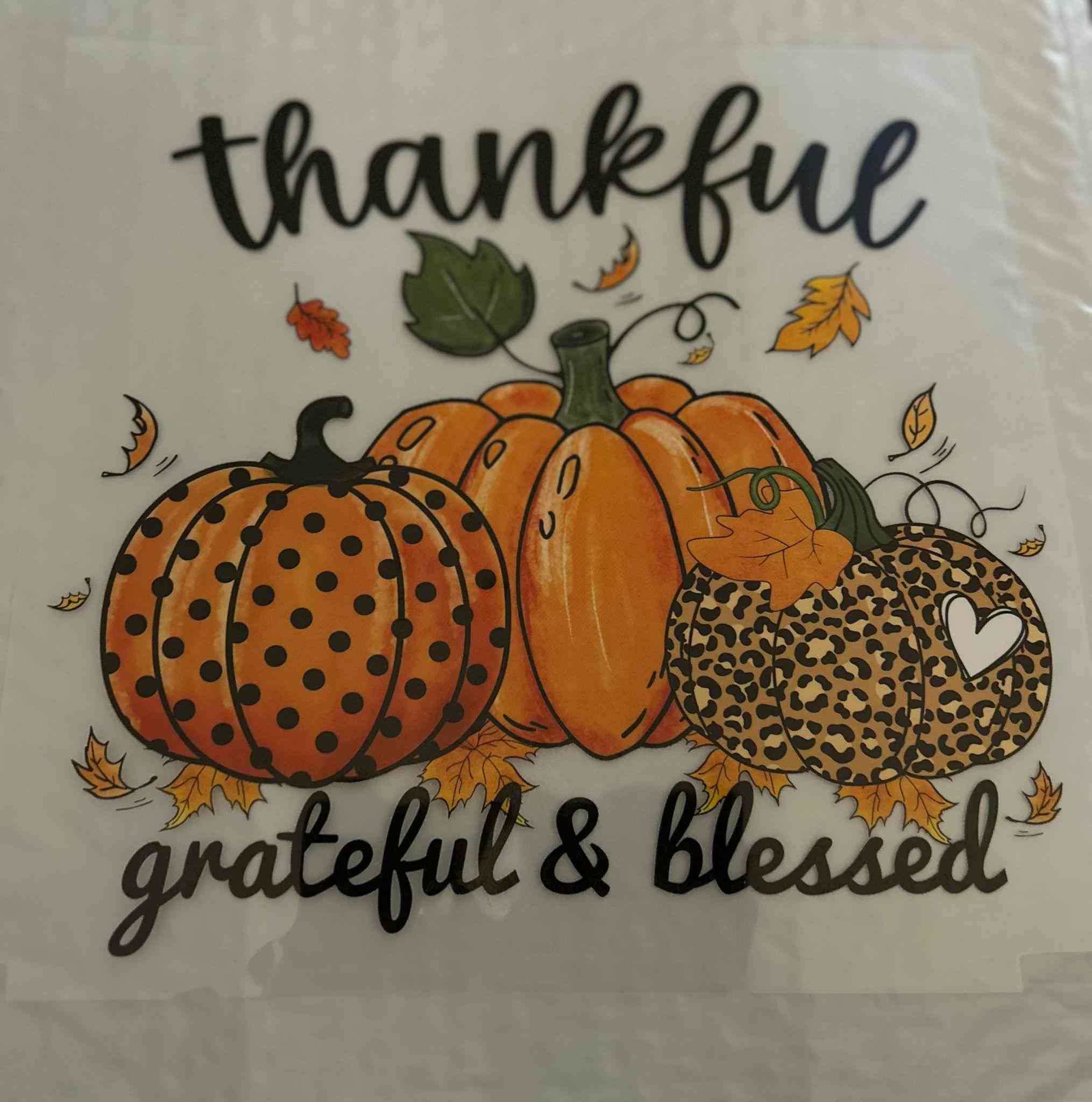 Thankful pumpkin design with &quot;grateful &amp; blessed&quot; text, featuring autumn elements for holiday &amp; season design.